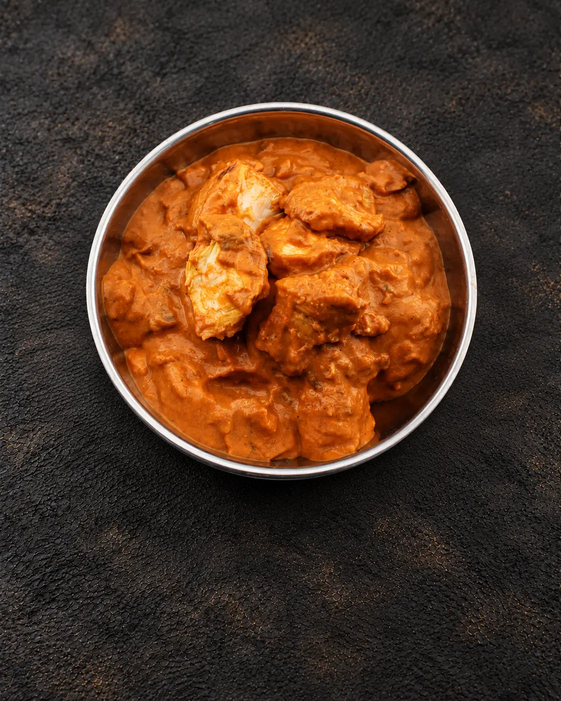 Creamy Tikka Masala curry in a steel bowl